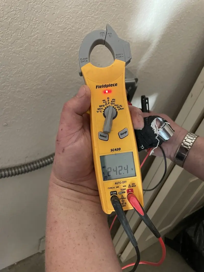 Voltage testing with clamp meter during Whole House Surge Protector in Waukesha
